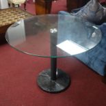 A contemporary circular dining table with glass top raised on marble base, Diameter 99cm