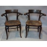 A pair of antique Thonet bent wood armchairs, both with paper label