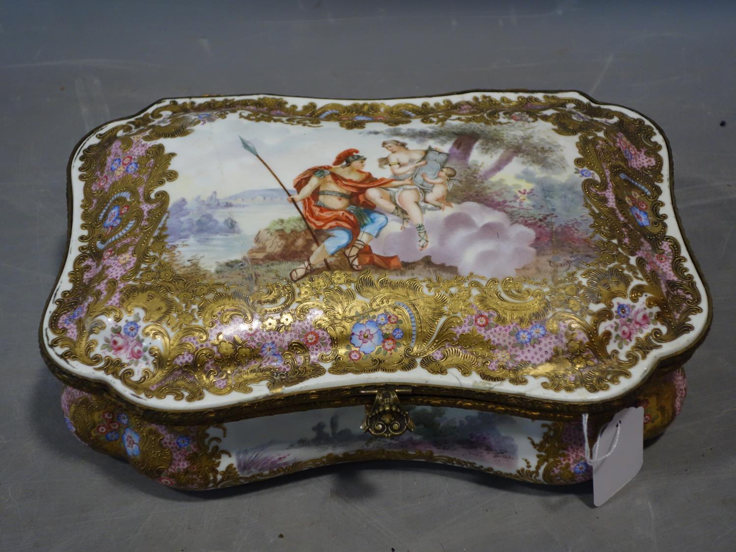 A late 19th/early 20th century hand painted porcelain casket, lid restored, H.10 W.32 D.22cm