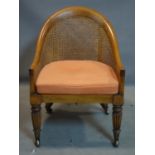 A 19th century caned walnut armchair, raised on reeded legs and castors