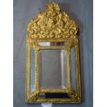 A gilt sheet metal clad mirror, with central rectangular glass plate within mirrored border,