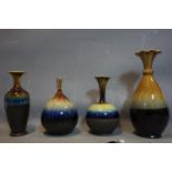 Four Persian drip glazed vases of varying size and form, H.38cm (largest)
