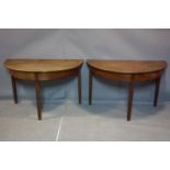 A pair of 19th century mahogany demi-lune tables on tapering legs, H.70 W.113 D.60cm