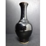 A Chinese black glazed vase, with elongated neck and everted rim, H.20cm