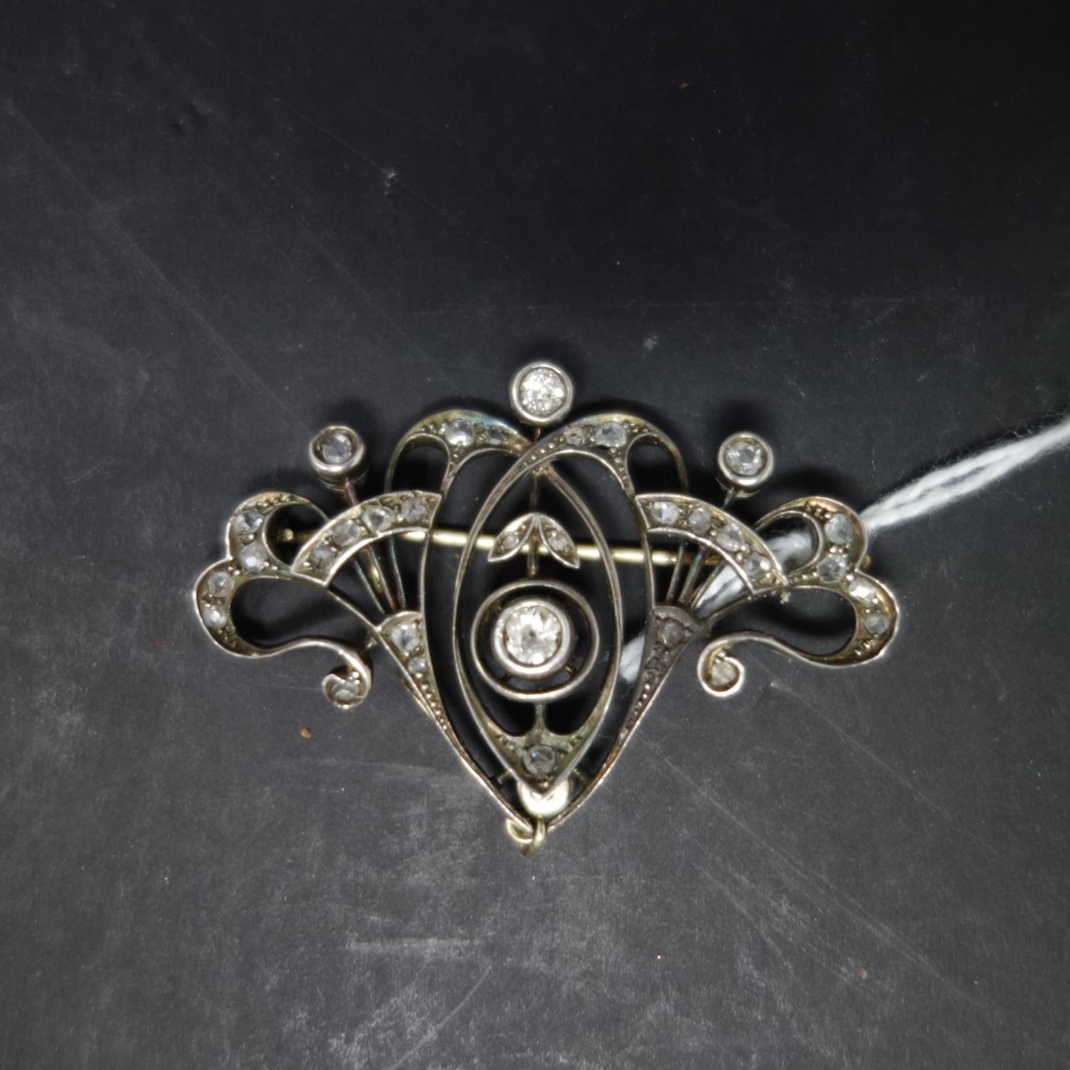 An Art Nouveau white metal and diamond set brooch, H.3.5 W.5cm