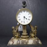 A 20th century French brass clock with Pharaoh head finial and 2 sphinx garnitures, raised on marble