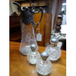 A pair of Victorian glass scent bottles with silver tops, together with a larger example by Mappin &