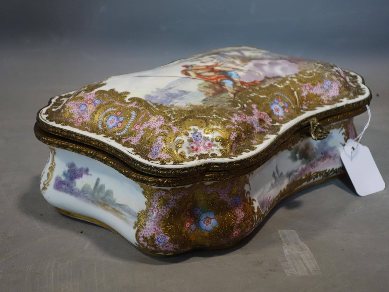 A late 19th/early 20th century hand painted porcelain casket, lid restored, H.10 W.32 D.22cm - Image 2 of 5