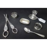 A collection of silver, to include two napkin rings, a teaspoon, a small gadrooned dish, and an