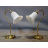A pair of vintage brass lamps with glass shades