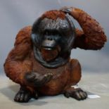 A fibreglass orangutan, H.40 W.48cm