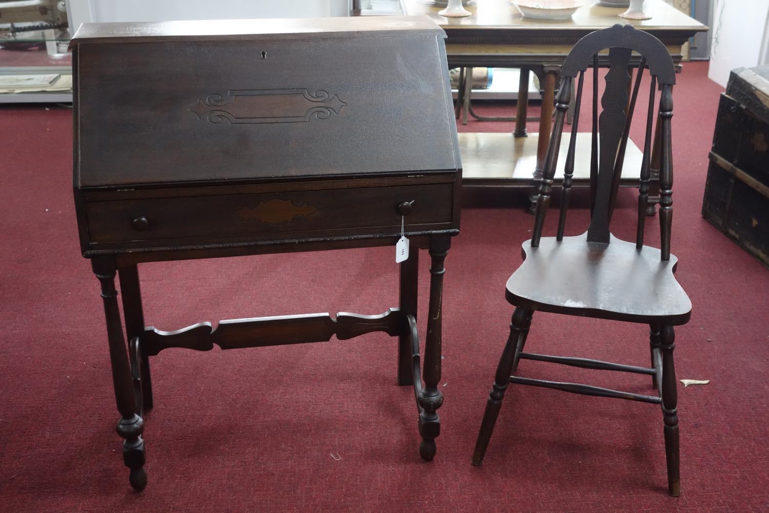 An oak bureau with desk chair