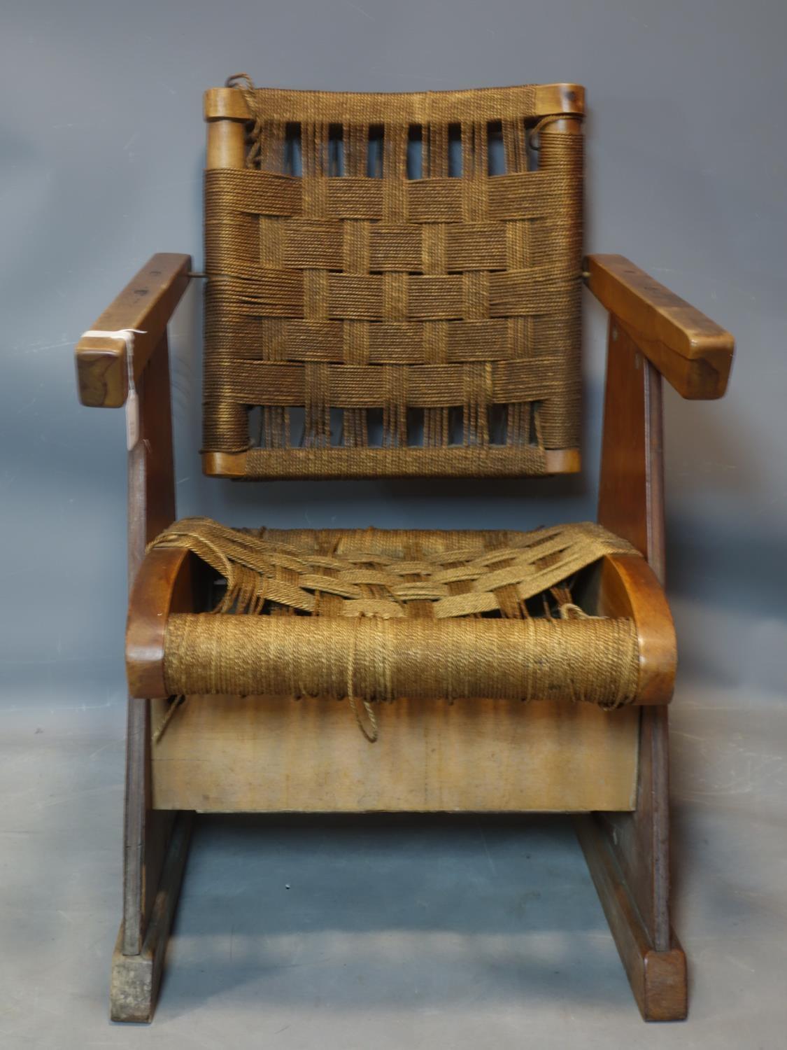 A vintage walnut and oak armchair with woven seat and back rest