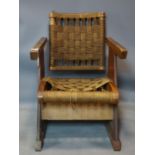 A vintage walnut and oak armchair with woven seat and back rest