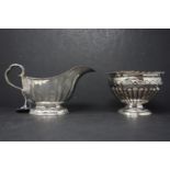 A silver milk jug by Atkin Brothers, Sheffield, date mark rubbed, H.11 W.20cm, together with a