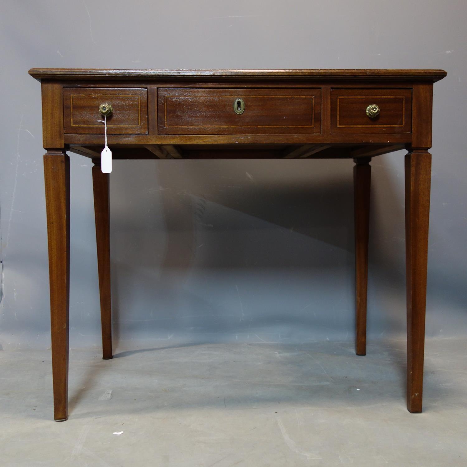 An early 20th century mahogany writing table, with leather top and 3 drawers, raised on tapered