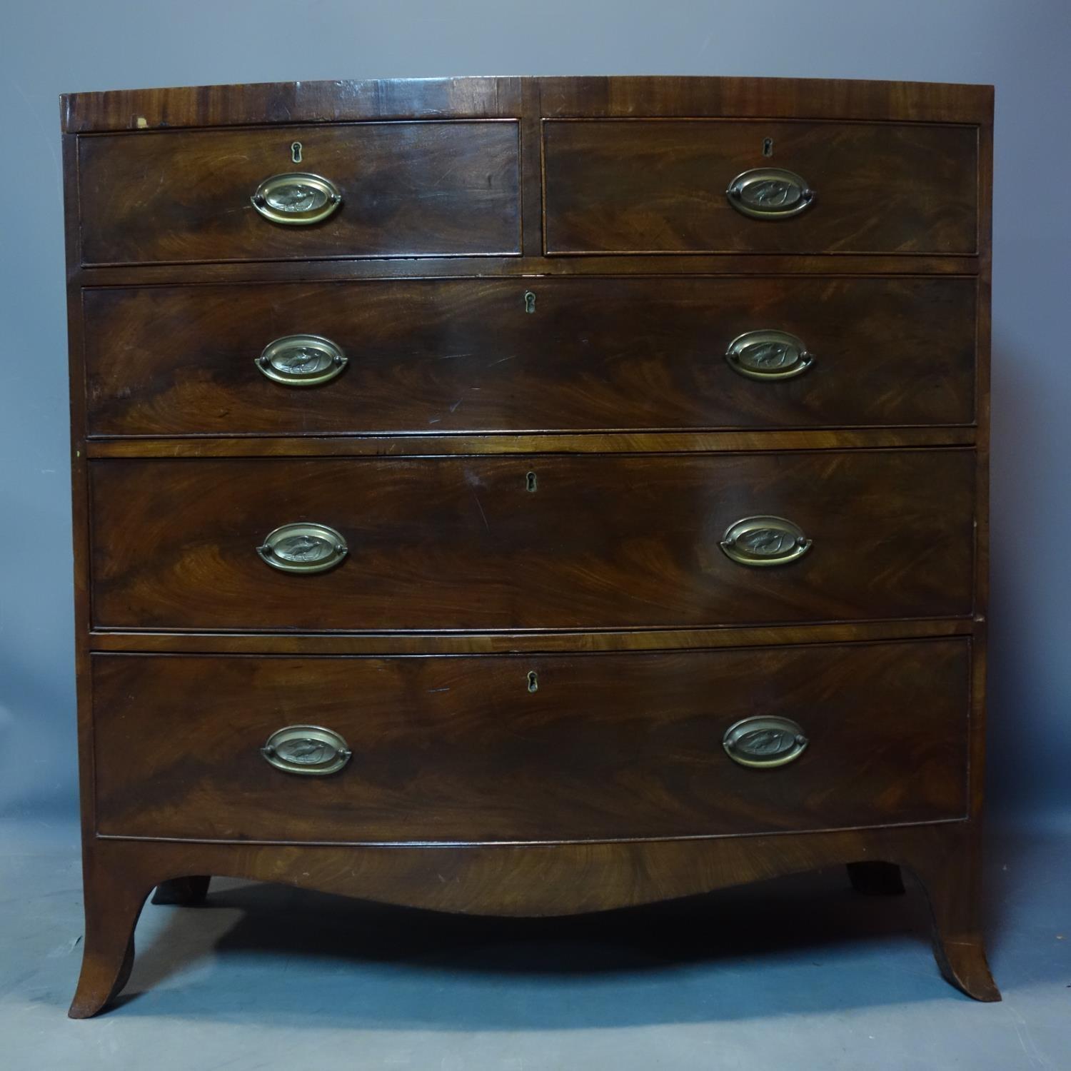 A Regency mahogany bow fronted chest of drawers, top warped, H.104 W.104 D.53cm