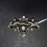 An Art Nouveau white metal and diamond set brooch, H.3.5 W.5cm