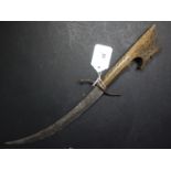 A 19th century Middle Eastern dagger, with curved blade and carved hardwood handle, L.39cm