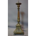 A 19th century copper pricket candlestick, with acanthus decoration raised on three lion paw feet,