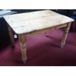 A 20th century pine kitchen table, raised on turned legs, H.74 W.120 D.89cm