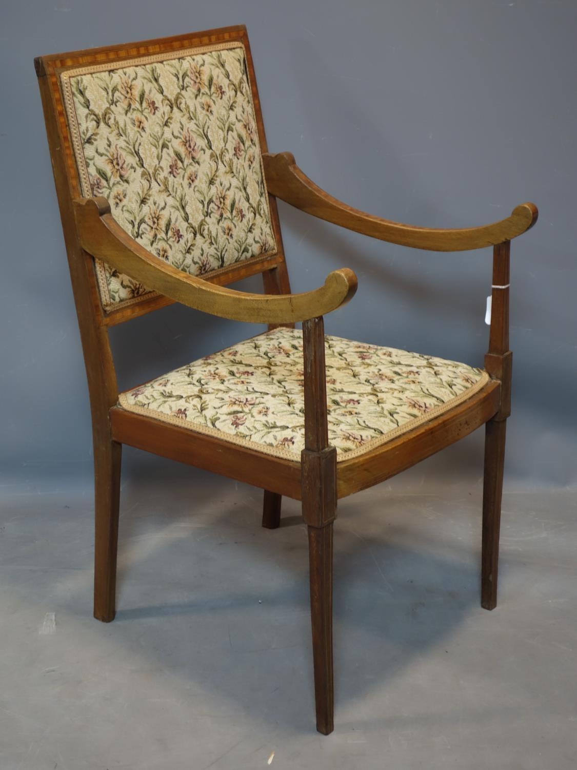 An Edwardian inlaid mahogany and satinwood crossbanded armchair, with sloped arms and floral