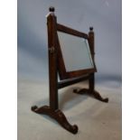 An early 19th century mahogany swing mirror, H.39 W.33 D.21cm
