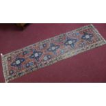 A 20th century north west Persian Heriz runner, with 5 geometric medallions surrounded by