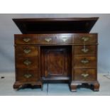 A Georgian mahogany architects desk, the hinged easel top above drawer with chinoiserie push back