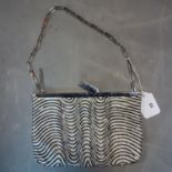 A vintage Gucci ladies evening bag, with black and white beaded design, H.15 W.22cm, with some