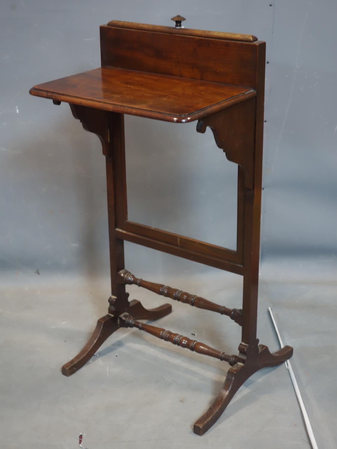 An Edwardian mahogany adjustable fire screen, lacking panel