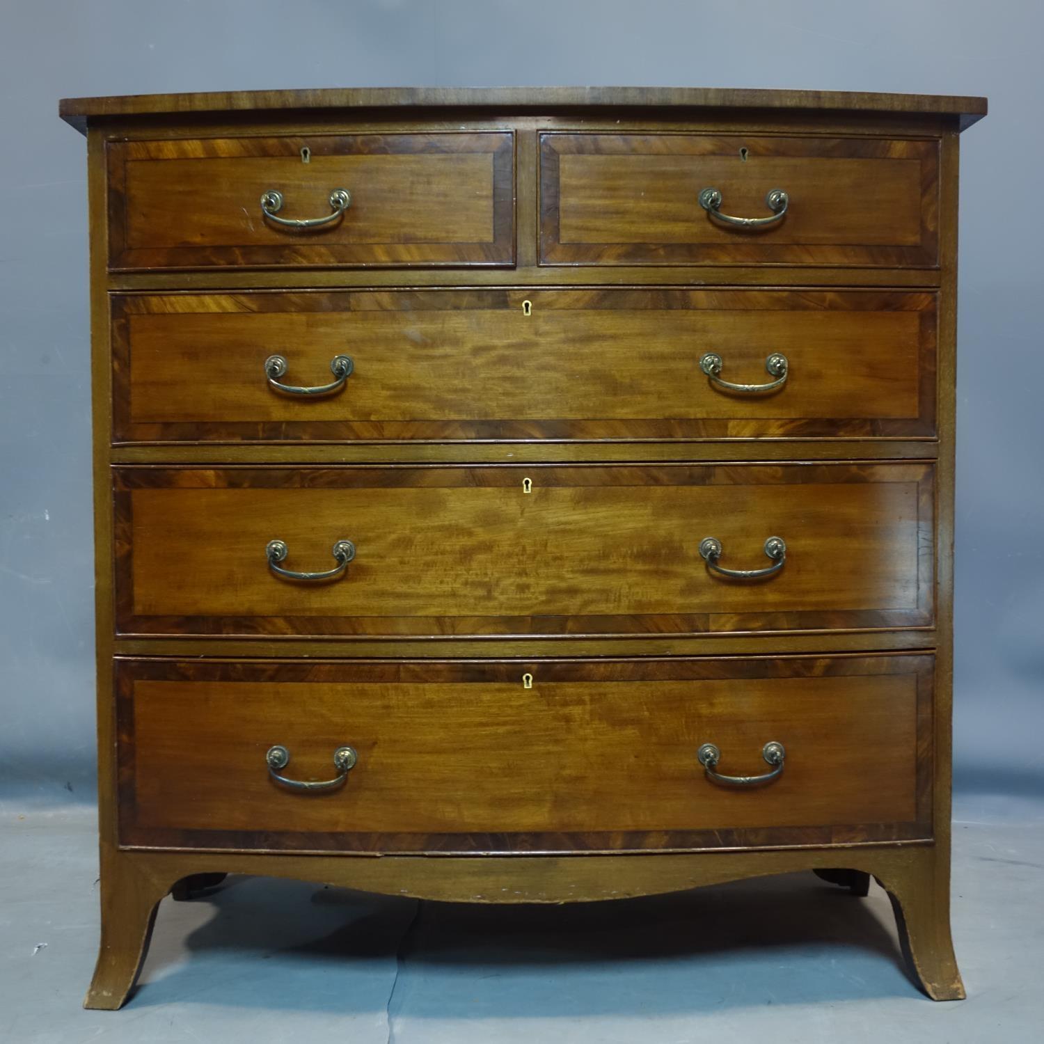 An early 19th century mahogany cross banded bow front chest of drawers, H.106 W.107 D.57cm