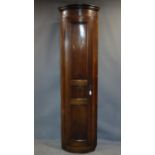 An early 19th century tall bow fronted mahogany corner cupboard, H.213 W.58 D.35cm