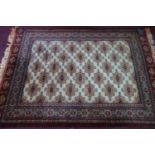 A Persian rug with repeating geometric motifs on a cream ground, within geometric borders, 279 x