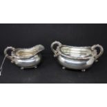 A silver cream jug and matching silver plated sugar bowl