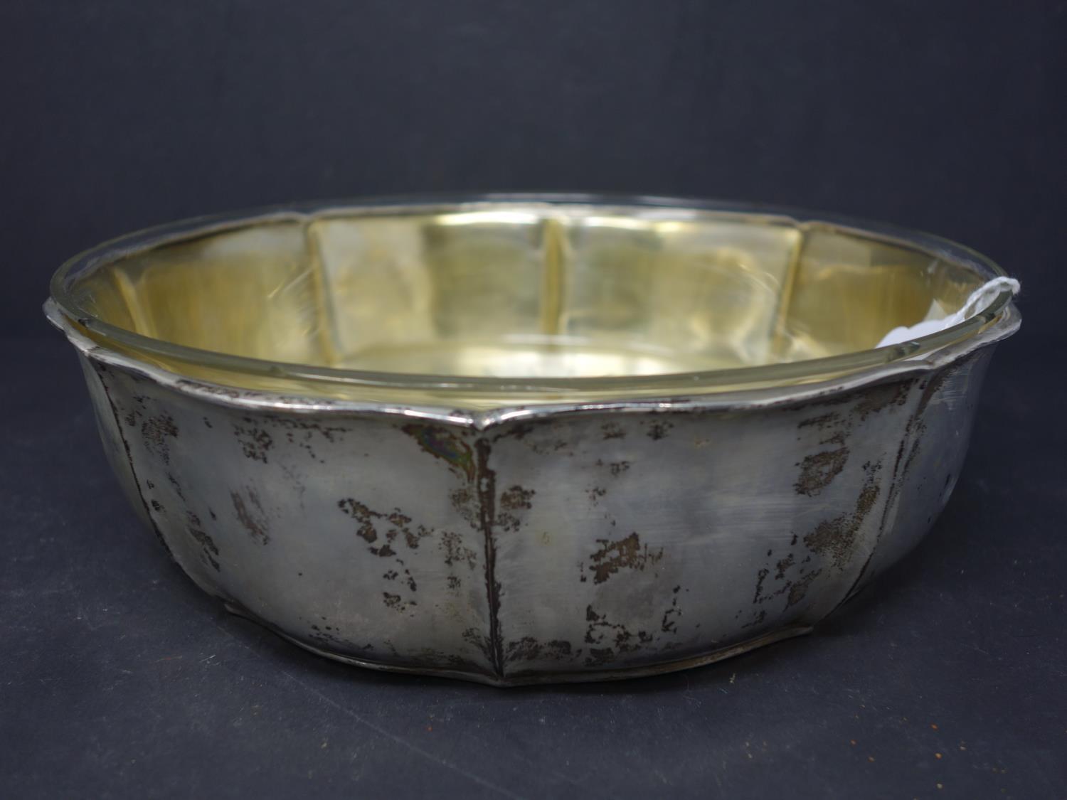 A German silver bowl with glass liner, 12.6 troy oz, H.7cm Diameter 24cm, chips to rim of glass