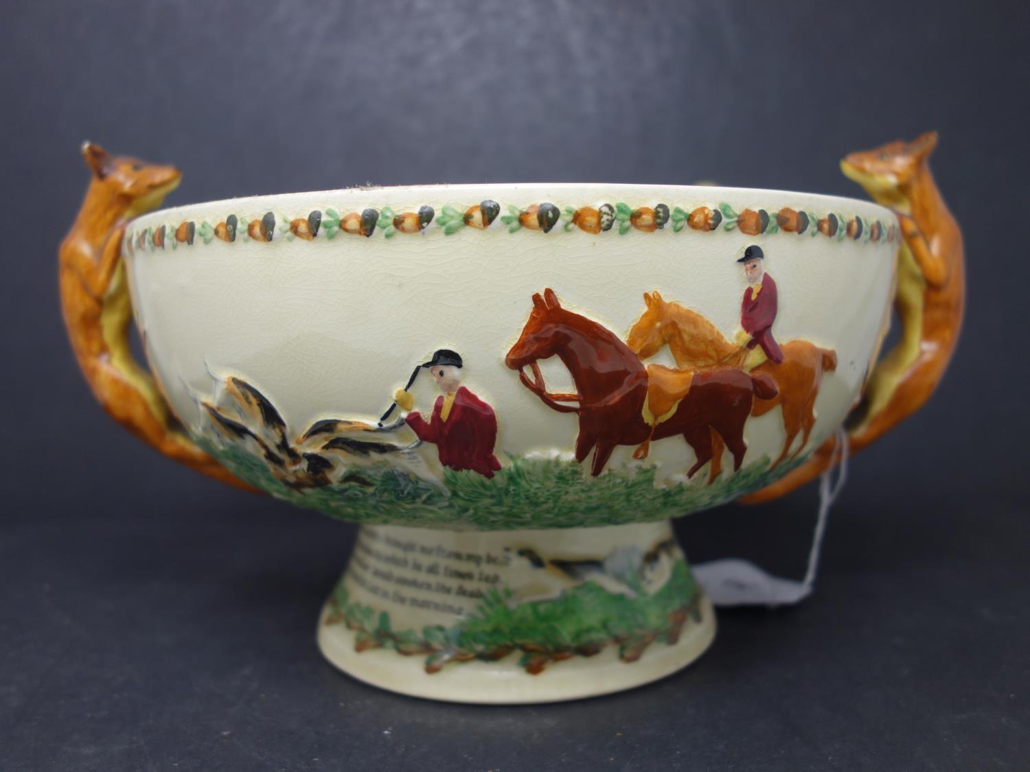 A Crown Devon bowl, with hunting decoration and twin fox handles, with matching spoon of horn