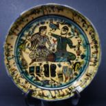 A Persian glazed ceramic bowl, decorated with two figures drinking to center, dated and marked to