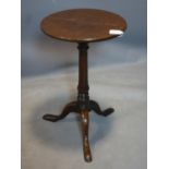 An 18th century and later oak circular wine table, on turned support and three outswept feet, H.65cm