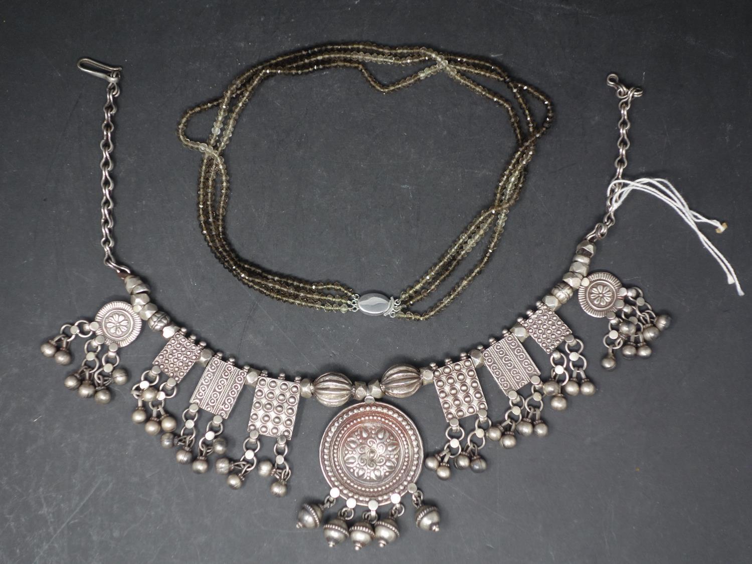 A white metal necklace together with a three strand beaded necklace, the clasp stamped 750 (2)