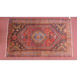 A Northwest Persian Hamadan rug, central diamond medallion with repeating animal motifs on a