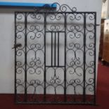 A vintage black painted wrought iron gate, 115 x 90cm