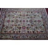A Persian Tabriz carpet, all over floral motifs on a cream ground within floral borders, 320 x 214cm