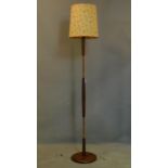 A 20th century teak and copper standard lamp, with shade, H.172cm