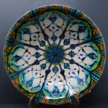 A Persian glazed ceramic bowl, decorated with geometric and floral motifs, dated and marked to base,