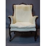 A Louis XV style mahogany wingback armchair, on cabriole legs, H.111 W.80cm, in need of re-
