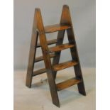 A late 19th/early 20th century mahogany folding set of library steps, with brass inlay, H.100cm