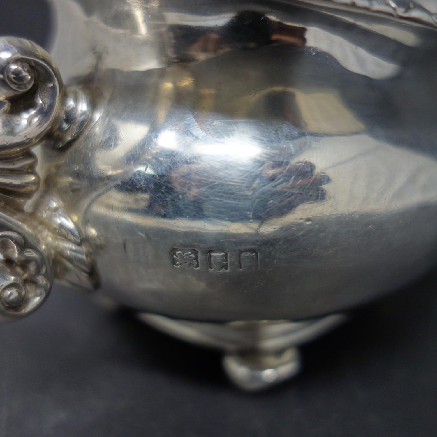 A silver cream jug with twin dragon head handles and shell and flower rims, hallmarked London, - Image 5 of 5
