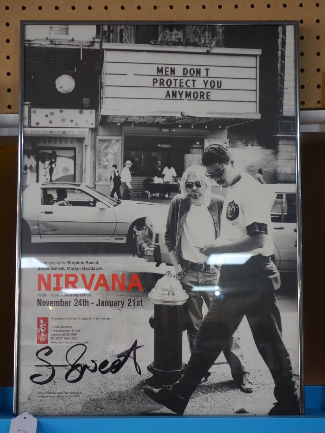 An exhibition poster, 'Nirvana- 1989-1993 A Retrospective', with signature in pen by photographer