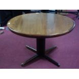 A walnut circular extending dining table with two extra leaves, H.74cm Diameter 115cm